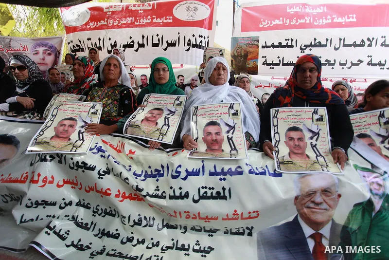 Families of Palestinian prisoners in the weekly sit-in to calling for the release of Palestinian prisoners from Israeli jails in front of the Red Cross in the West Bank City of Ramalla, on Sep. 24, 2013. Photo by Issam R...