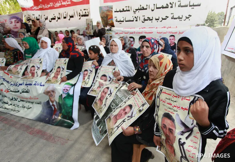 Families of Palestinian prisoners in the weekly sit-in to calling for the release of Palestinian prisoners from Israeli jails in front of the Red Cross in the West Bank City of Ramalla, on Sep. 24, 2013. Photo by Issam R...