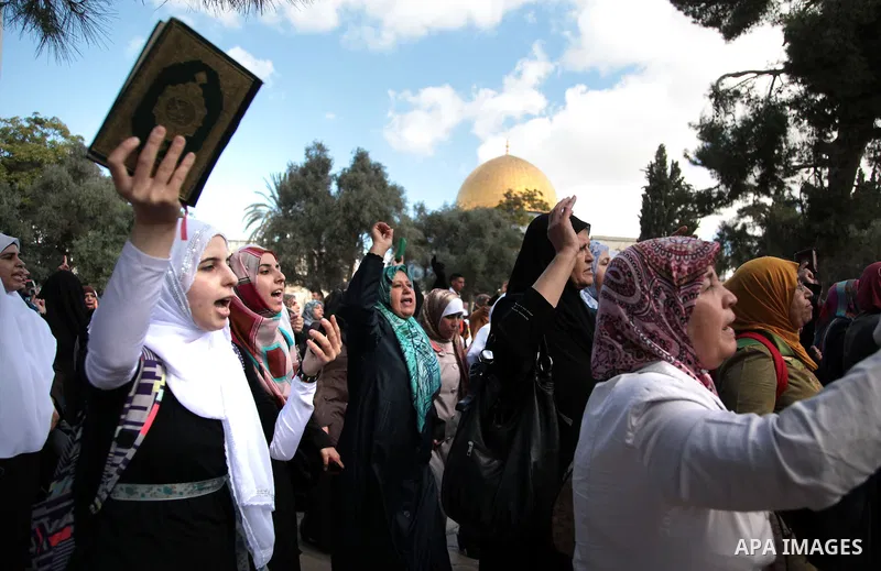 Palestinian women protest following minor clashes at the compound known to Muslims as Noble Sanctuary and to Jews as Temple Mount in Jerusalem's Old City, as the Dome of the Rock is seen in the background September 25, 2...