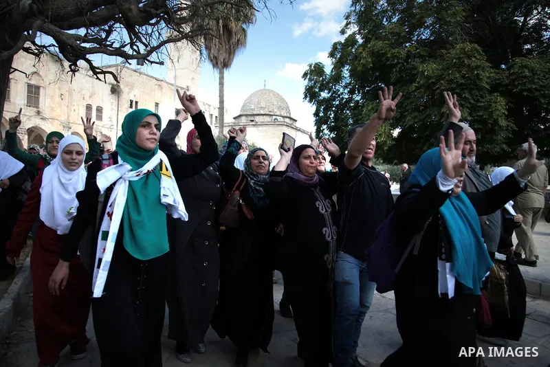 Palestinian women protest following minor clashes at the compound known to Muslims as Noble Sanctuary and to Jews as Temple Mount in Jerusalem's Old City, as the Dome of the Rock is seen in the background September 25, 2...