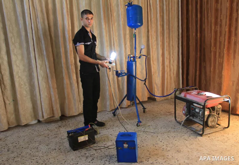 Palestinian student, Ibrahim Saad, 18, invents device "X_Zero Water Volt"، in Gaza City, on Sep. 25, 2013. The device produce hydrogen gas by analysing water, which uses to run an electricity generator and as cooking gas...