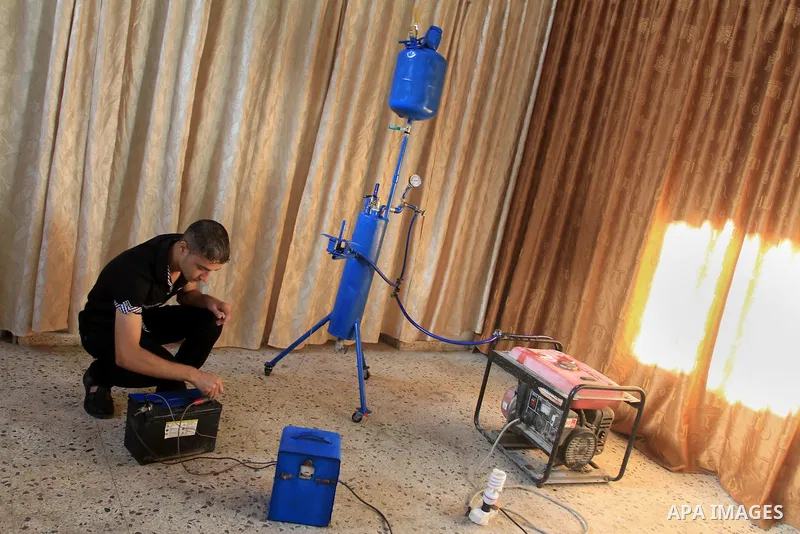 Palestinian student, Ibrahim Saad, 18, invents device "X_Zero Water Volt"، in Gaza City, on Sep. 25, 2013. The device produce hydrogen gas by analysing water, which uses to run an electricity generator and as cooking gas...