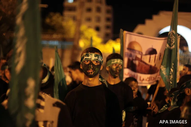 Palestinian Hamas supporters hold movement flags during a rally marking 13th anniversary of the so-called Al-Aqsa uprising or 'Second Intifada', and against visits to a disputed Jerusalem holy site by religious Jews, cla...