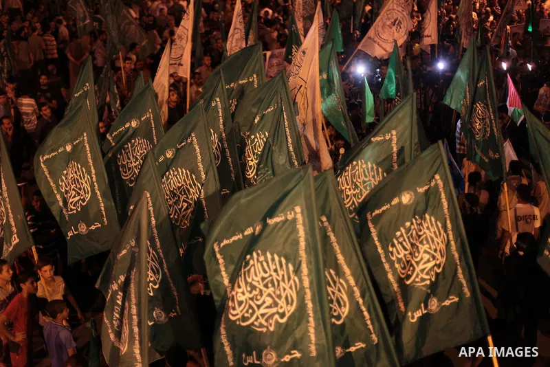 Palestinian Hamas supporters hold movement flags during a rally marking 13th anniversary of the so-called Al-Aqsa uprising or 'Second Intifada', and against visits to a disputed Jerusalem holy site by religious Jews, cla...