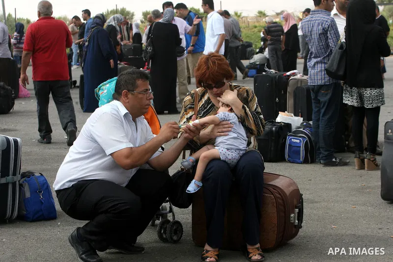 Palestinians wait at the Rafah border crossing in the southern Gaza Strip on September 28, 2013, for a brief opening allowing special cases to cross after Egyptian authorities closed the crossing "indefinitely" the day b...