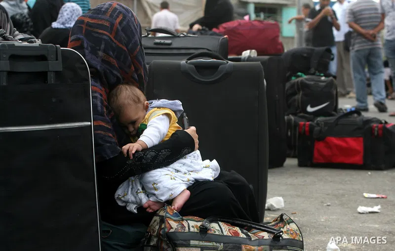 Palestinians wait at the Rafah border crossing in the southern Gaza Strip on September 28, 2013, for a brief opening allowing special cases to cross after Egyptian authorities closed the crossing "indefinitely" the day b...