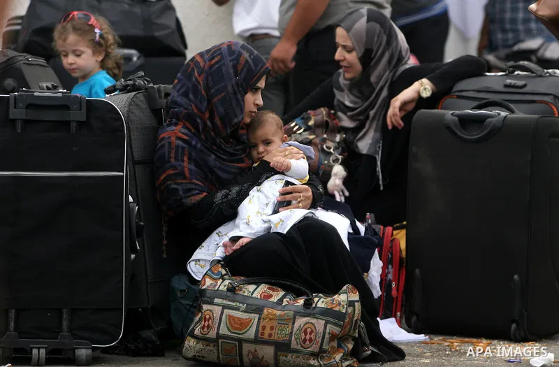 Palestinians wait at the Rafah border crossing in the southern Gaza Strip on September 28, 2013, for a brief opening allowing special cases to cross after Egyptian authorities closed the crossing "indefinitely" the day b...