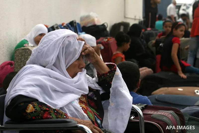 Palestinians wait at the Rafah border crossing in the southern Gaza Strip on September 28, 2013, for a brief opening allowing special cases to cross after Egyptian authorities closed the crossing "indefinitely" the day b...
