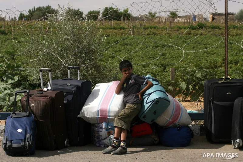 Palestinians wait at the Rafah border crossing in the southern Gaza Strip on September 28, 2013, for a brief opening allowing special cases to cross after Egyptian authorities closed the crossing "indefinitely" the day b...
