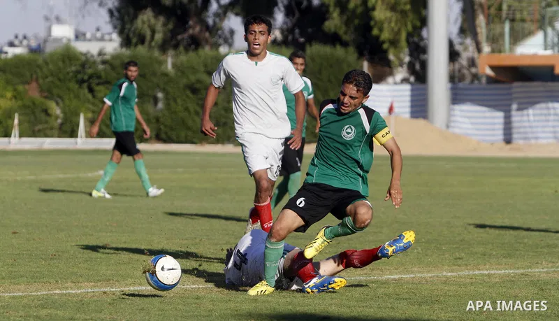 Palestinian soccer team Union Shijaia club compete against Islamic Society club during the Premier League in Gaza City on Sept. 28, 2013. Union Shijaia club beat off Islamic society club 2-0. Photo by Alaa Shamaly