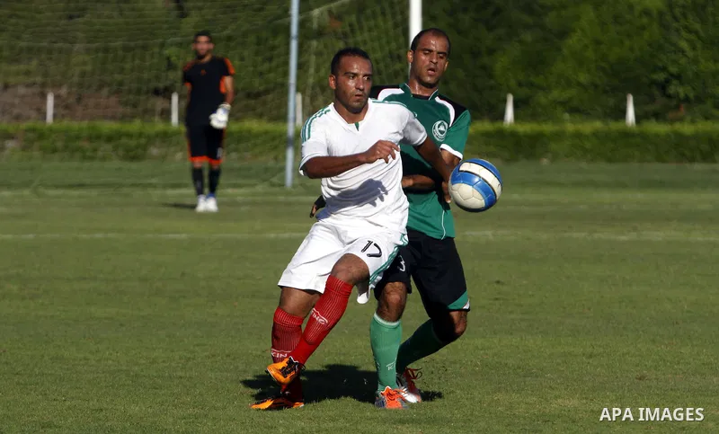 Palestinian soccer team Union Shijaia club compete against Islamic Society club during the Premier League in Gaza City on Sept. 28, 2013. Union Shijaia club beat off Islamic society club 2-0. Photo by Alaa Shamaly