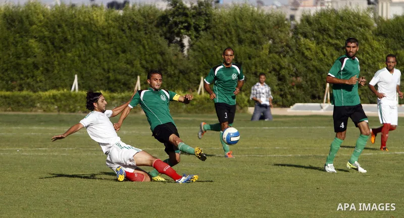 Palestinian soccer team Union Shijaia club compete against Islamic Society club during the Premier League in Gaza City on Sept. 28, 2013. Union Shijaia club beat off Islamic society club 2-0. Photo by Alaa Shamaly