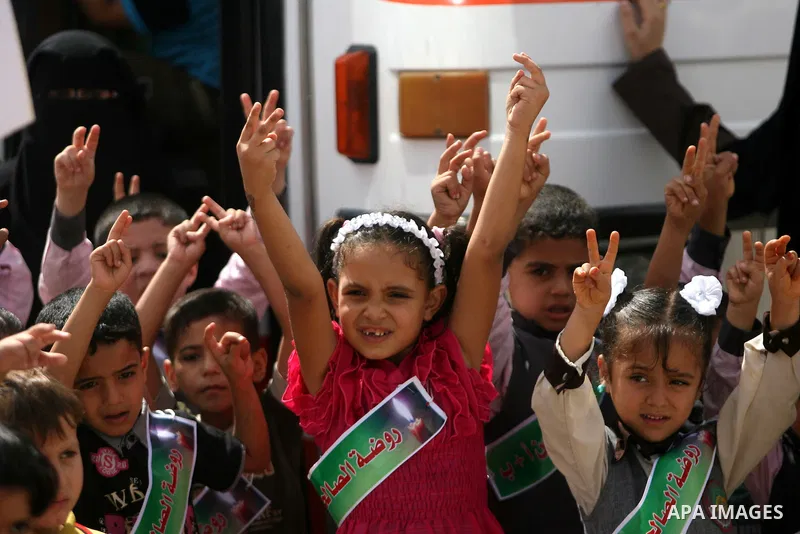 Palestinian children take part in a protest calling on Egyptian authorities to open the Rafah border crossing in front of the Rafah crossing between Egypt and the southern Gaza Strip on September 29, 2013. Hundreds of pa...