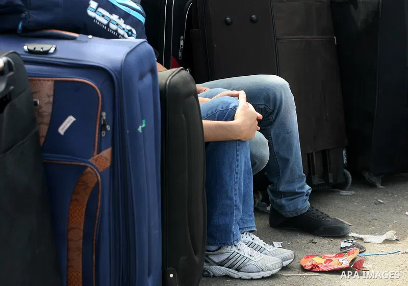 Palestinians wait to cross into Egypt at the Rafah crossing between Egypt and the southern Gaza Strip on September 29, 2013. Hundreds of patients, students and foreign residents from the Palestinian side have rushed to t...