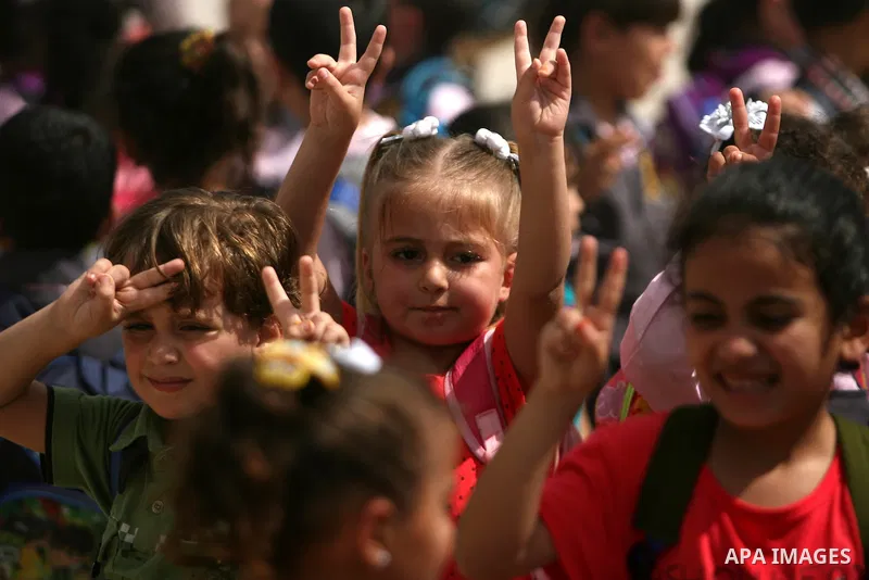 Palestinian children take part in a protest calling on Egyptian authorities to open the Rafah border crossing in front of the Rafah crossing between Egypt and the southern Gaza Strip on September 29, 2013. Hundreds of pa...