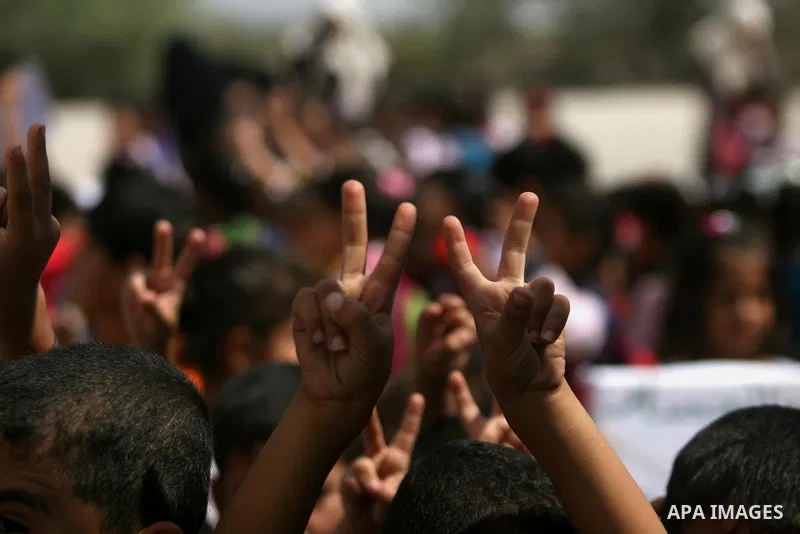 Palestinian children take part in a protest calling on Egyptian authorities to open the Rafah border crossing in front of the Rafah crossing between Egypt and the southern Gaza Strip on September 29, 2013. Hundreds of pa...