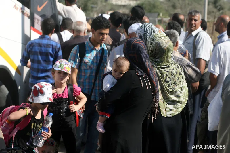 Palestinian passengers, hoping to cross into Egypt, searches for her bag as she waits at the Rafah crossing, between Egypt and the southern Gaza Strip, September 30, 2013. Egypt partially reopened its border crossing wit...