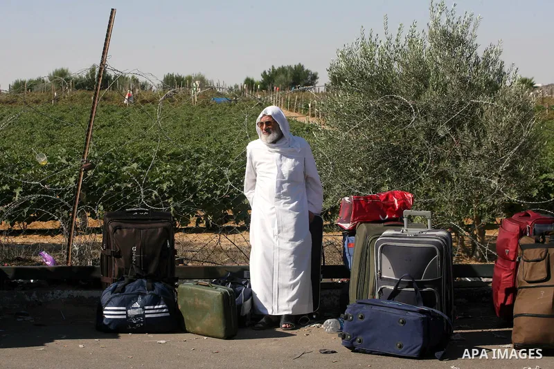 Palestinian passengers, hoping to cross into Egypt, searches for her bag as she waits at the Rafah crossing, between Egypt and the southern Gaza Strip, September 30, 2013. Egypt partially reopened its border crossing wit...
