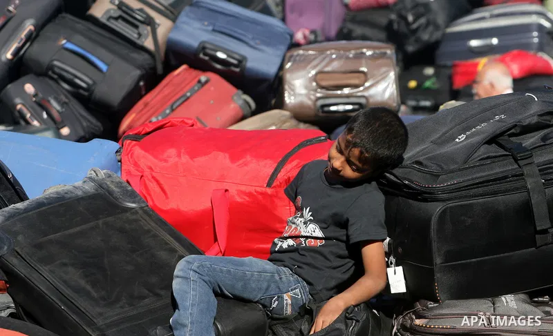 A Palestinian passenger, hoping to cross into Egypt, searches for her bag as she waits at the Rafah crossing, between Egypt and the southern Gaza Strip, September 30, 2013. Egypt partially reopened its border crossing wi...