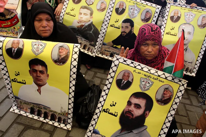 Families of Palestinian prisoners in the weekly sit-in to calling for the release of Palestinian prisoners from Israeli jails in front of the Red Cross in Gaza City, on Sep. 30, 2013. Photo by Mohammed Asad