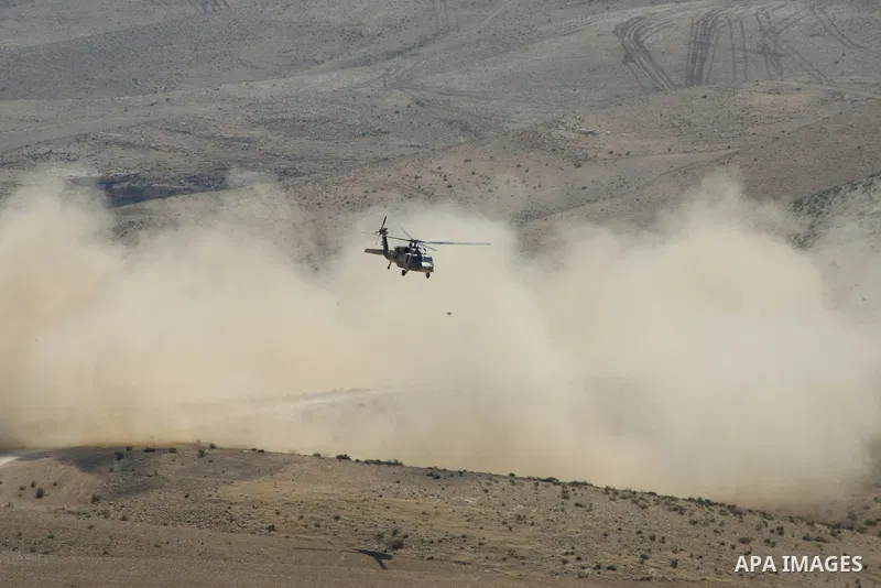 An Israeli military helicopter flies over the Massafer Yatta area, near the West Bank City of Hebron, on 01 October 2013. According to reports, Palestinian citizens in the area south of Yatta must leave while Israeli gov...