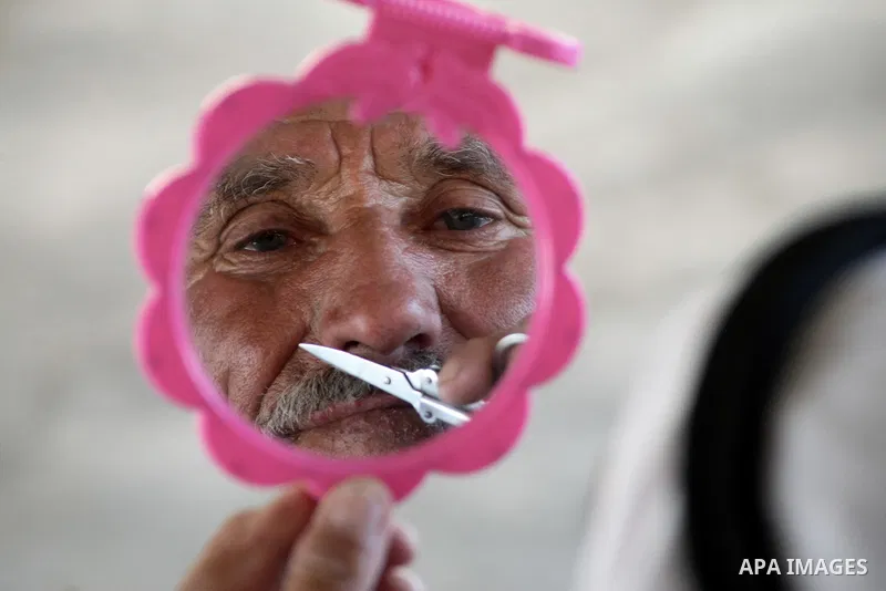 A Palestinian man shaves his moustache at his tent in the village of Jimba southern Yatta, near the West Bank City of Hebron, on 01 October 2013. According to reports, Palestinian citizens in the area south of Yatta must...