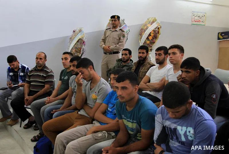 Palestinian prisoners wait to leave the prison run by the security forces in Gaza Strip, in Gaza City on Oct.13, 2013 Security officials in Gaza Strip said on Sunday they released 51 criminal prisoners occasion fo the Mu...