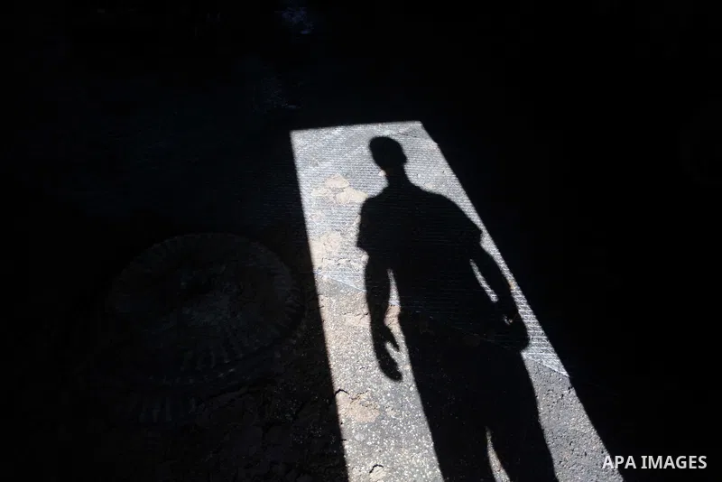A Palestinian worker stands at the entrance of a traditional stone press in Gaza City, 20 October 2013. Regional farmers are harvesting their olives this year from mid-October until 01 November. According to figures issu...