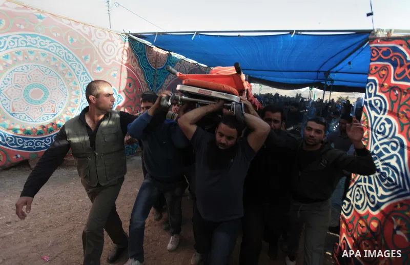 Palestinian mourners carry the body of Younis al-Radaideh during his funeral in Ubiedyeh village near the West Bank city of Bethlehem, Oct. 21, 2013. Israeli forces on Thursday shot and killed Younis Ahmed Radaideh, 28,...