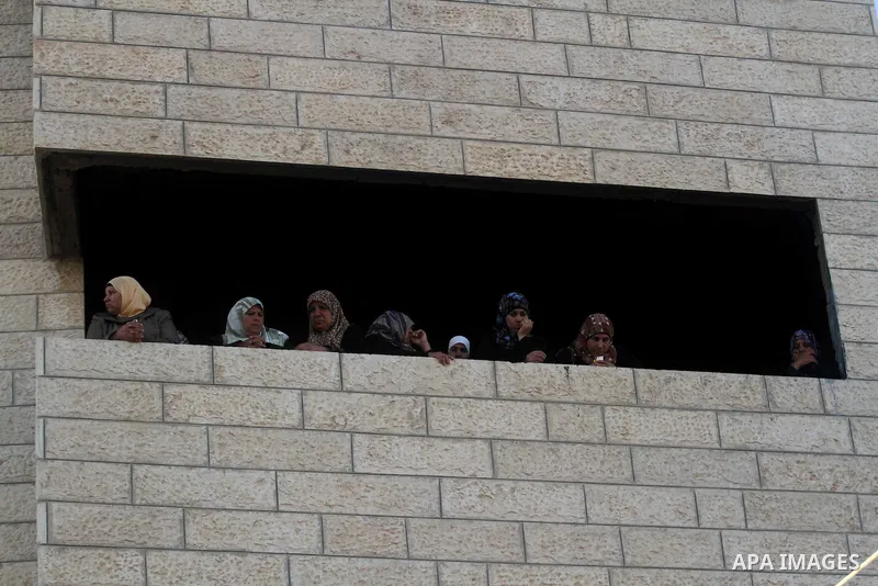 Palestinian women look on during the funeral of Younis al-Radaideh in Ubiedyeh village near the West Bank city of Bethlehem, Oct. 21, 2013. Israeli forces on Thursday shot and killed Younis Ahmed Radaideh, 28, after he w...