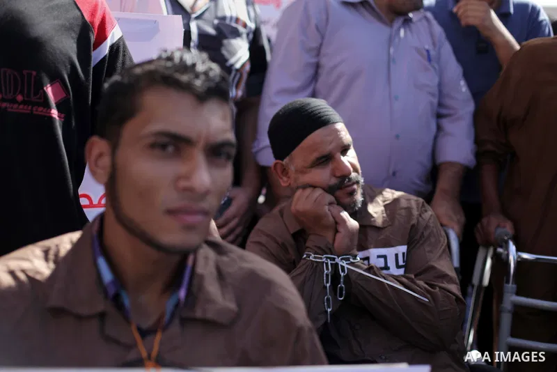 Palestinian supporters of the Islamic Jihad militant group participate in a protest in solidarity with palestinian prisoners held in Israeli jails, in front of the headquarters of the United Nations (UNRWA) in Gaza City,...
