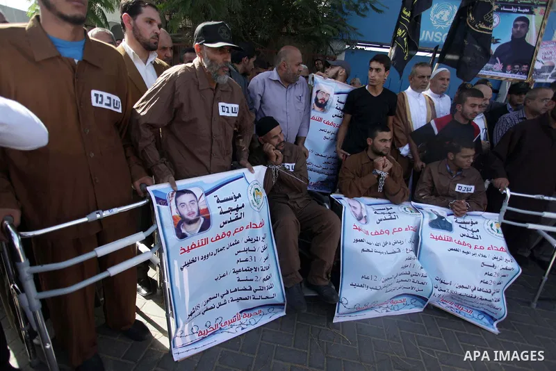 Palestinian supporters of the Islamic Jihad militant group participate in a protest in solidarity with palestinian prisoners held in Israeli jails, in front of the headquarters of the United Nations (UNRWA) in Gaza City,...