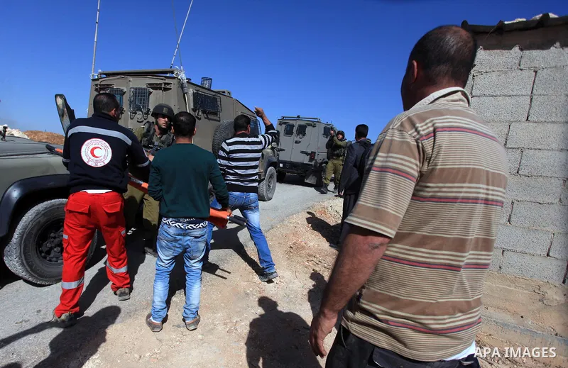Palestinian youths clash with Israeli forces that led to killing of Palestinian Islamic Jihad militant Mohamed Assi in the village of Bilin near the West Bank city of Ramallah, Tuesday, Oct. 22, 2013. Israel's security s...