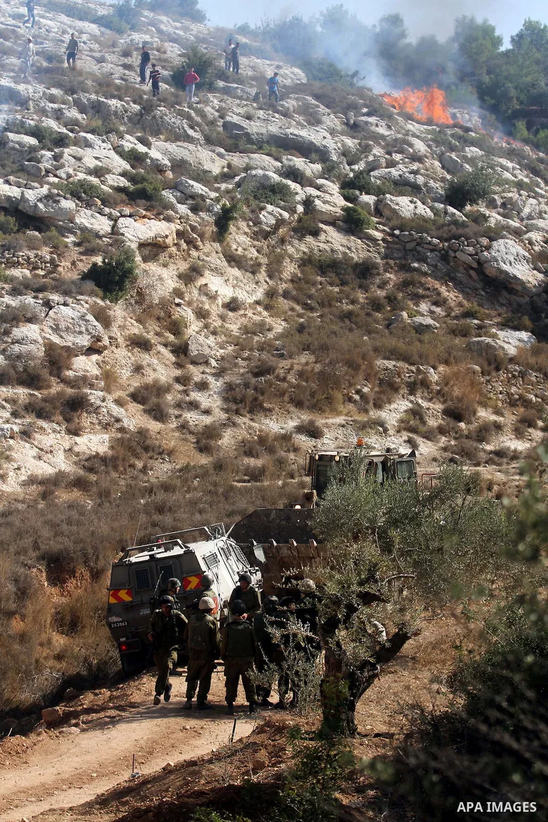 Israeli soldiers take position during clashes with Palestinian youths that led to killing of Palestinian Islamic Jihad militant Mohamed Assi in the village of Bilin near the West Bank city of Ramallah, Tuesday, Oct. 22,...