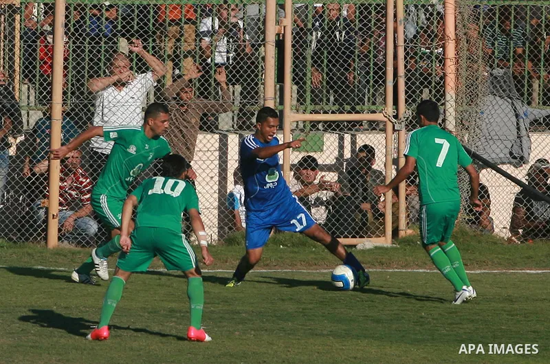Palestinian soccer team of Rafah services club compete against team of Rafah youth in Rafah in souther Gaza Strip on Oct. 25, 2013. The match ended in a goalless draw. Photo by Eyad Al Baba