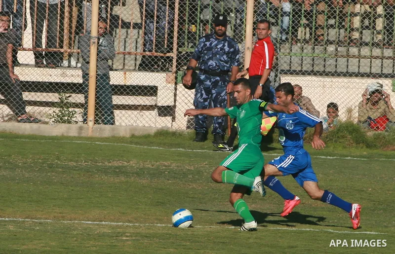 Palestinian soccer team of Rafah services club compete against team of Rafah youth in Rafah in souther Gaza Strip on Oct. 25, 2013. The match ended in a goalless draw. Photo by Eyad Al Baba