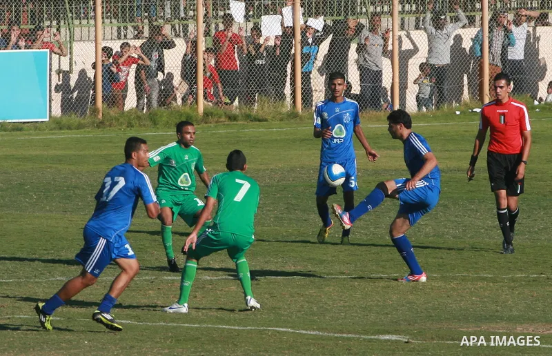 Palestinian soccer team of Rafah services club compete against team of Rafah youth in Rafah in souther Gaza Strip on Oct. 25, 2013. The match ended in a goalless draw. Photo by Eyad Al Baba