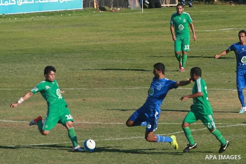 Palestinian soccer team of Rafah services club compete against team of Rafah youth in Rafah in souther Gaza Strip on Oct. 25, 2013. The match ended in a goalless draw. Photo by Eyad Al Baba