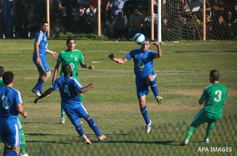 Palestinian soccer team of Rafah services club compete against team of Rafah youth in Rafah in souther Gaza Strip on Oct. 25, 2013. The match ended in a goalless draw. Photo by Eyad Al Baba