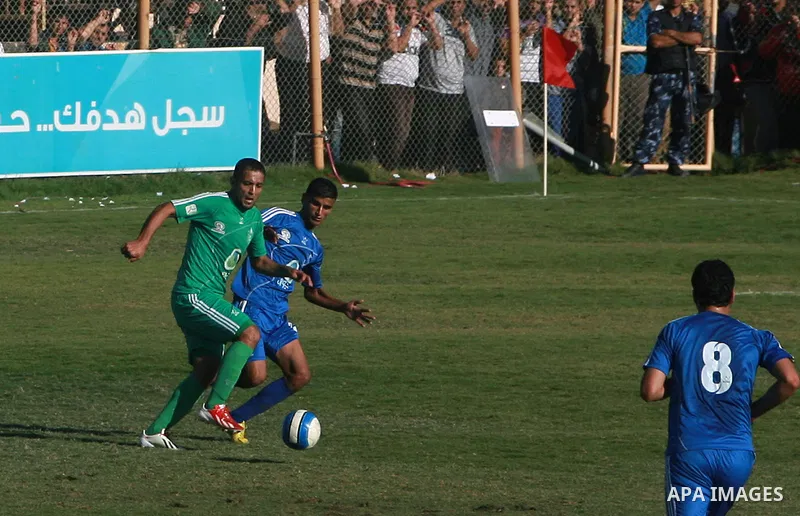 Palestinian soccer team of Rafah services club compete against team of Rafah youth in Rafah in souther Gaza Strip on Oct. 25, 2013. The match ended in a goalless draw. Photo by Eyad Al Baba