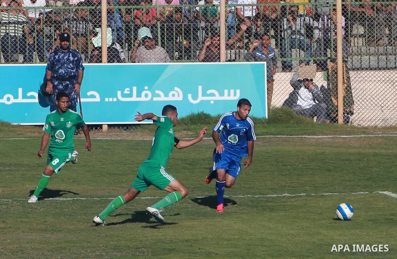 Palestinian soccer team of Rafah services club compete against team of Rafah youth in Rafah in souther Gaza Strip on Oct. 25, 2013. The match ended in a goalless draw. Photo by Eyad Al Baba