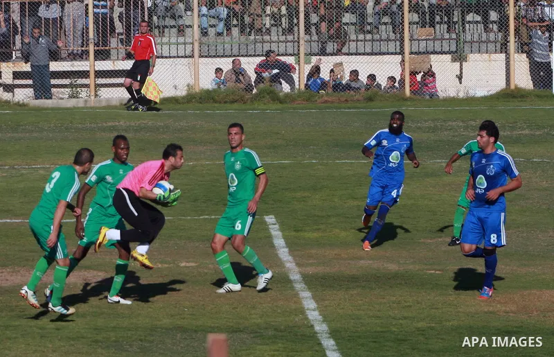 Palestinian soccer team of Rafah services club compete against team of Rafah youth in Rafah in souther Gaza Strip on Oct. 25, 2013. The match ended in a goalless draw. Photo by Eyad Al Baba