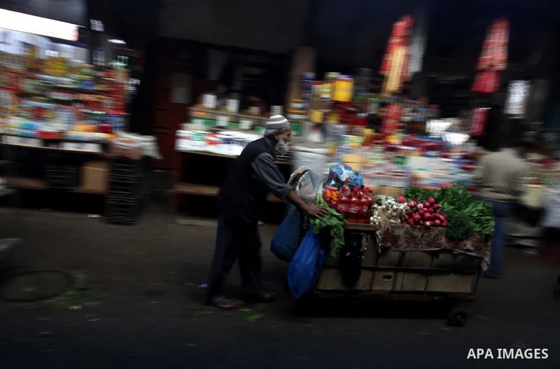 A Palestinian man sells vegetables at a street market in Gaza City on Oct. 27, 2013. Photo by Ashraf Amra
