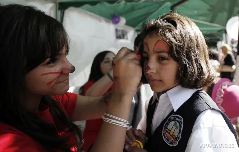 Palestinians take part in the annual Jerusalem's cakes festival in the east Jerusalem neighborhood of Sheikh Jarrah, Oct. 27, 2013. The Jerusalem's cakes festival is an annual carnival that inviting Palestinian children,...