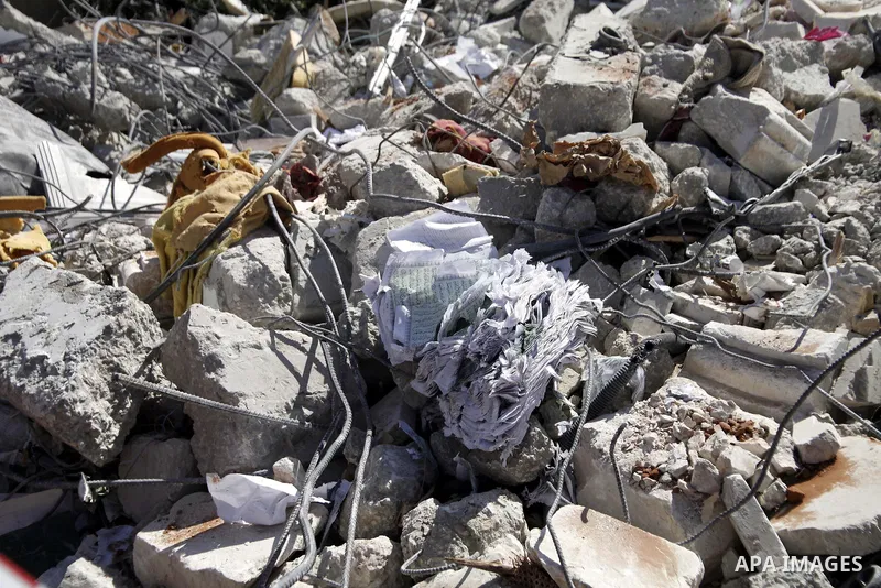 A copy of Koran is seen between remains of a house, belonging to a Palestinian family after demolished by Israeli Municipality in the East Jerusalem neighbourhood of Beit Hanina, October 29, 2013. A statement from the Je...