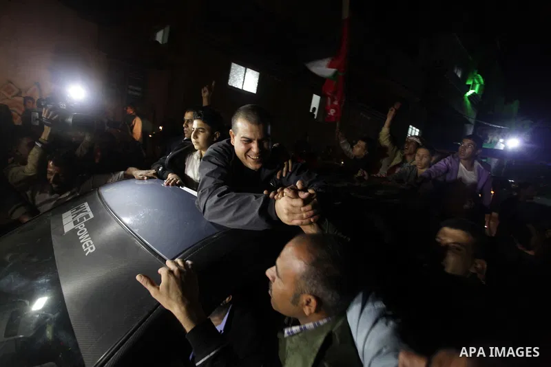 A released Palestinian prisoner is greeted by people upon his arrival at Erez crossing between Israel and northern Gaza Strip October 30, 2013. Israel freed 26 Palestinian prisoners on Wednesday, the second stage of a li...