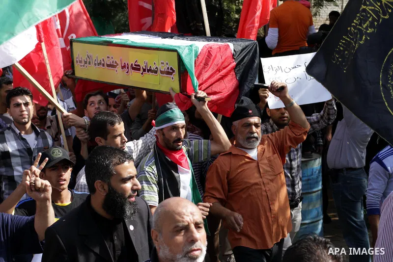 Palestinians take part in a military funeral for palestinian prisoner Hasan Turabi, in Gaza city 06 November 2013. who he died while serving a sentence in an Israeli prison. According to local news reports, Turabi, who w...