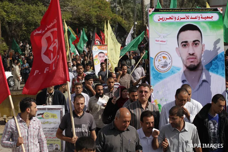 Palestinians take part in a military funeral for palestinian prisoner Hasan Turabi, in Gaza city 06 November 2013. who he died while serving a sentence in an Israeli prison. According to local news reports, Turabi, who w...