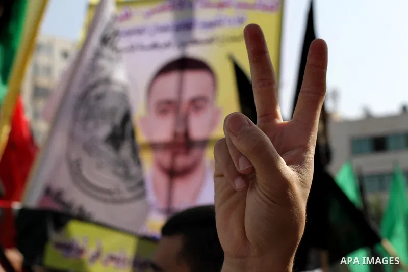 Palestinians take part in a military funeral for palestinian prisoner Hasan Turabi, in Gaza city 06 November 2013. who he died while serving a sentence in an Israeli prison. According to local news reports, Turabi, who w...