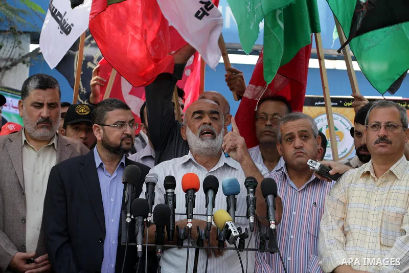 Palestinians take part in a military funeral for palestinian prisoner Hasan Turabi, in Gaza city 06 November 2013. who he died while serving a sentence in an Israeli prison. According to local news reports, Turabi, who w...